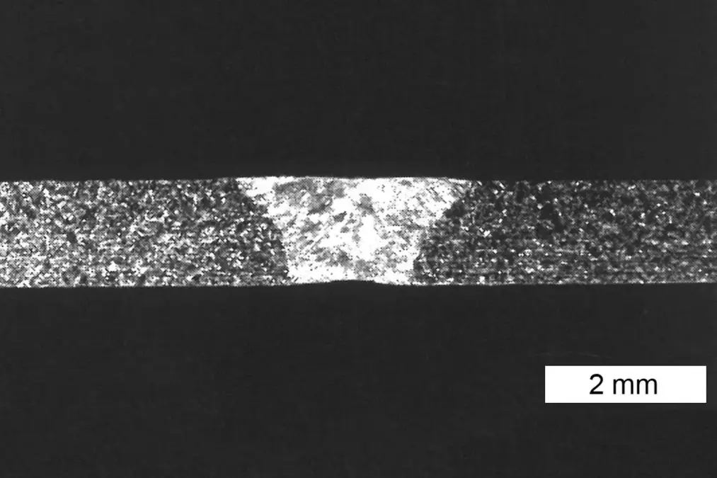 Cross section of a WIG orbital weld with fusion zone, heat-affected areas, and a 2 mm scale bar